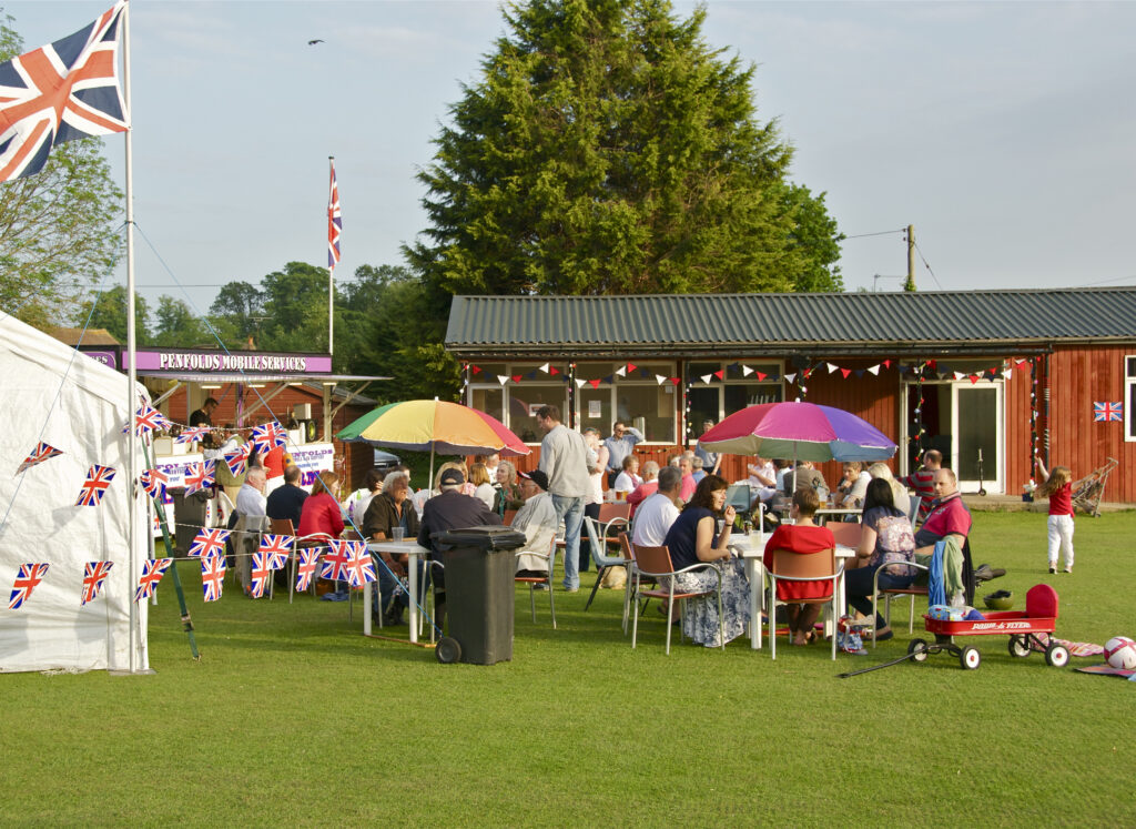 celebration on playing field in front of Walberton pavilion